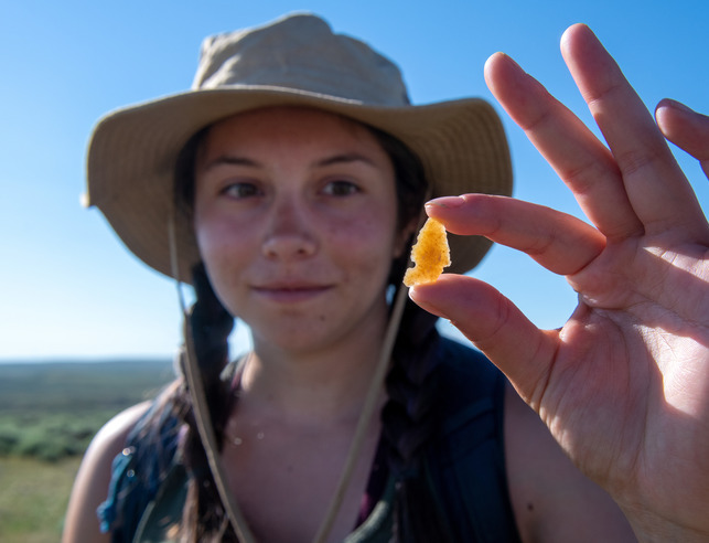Student holding up an arrow head