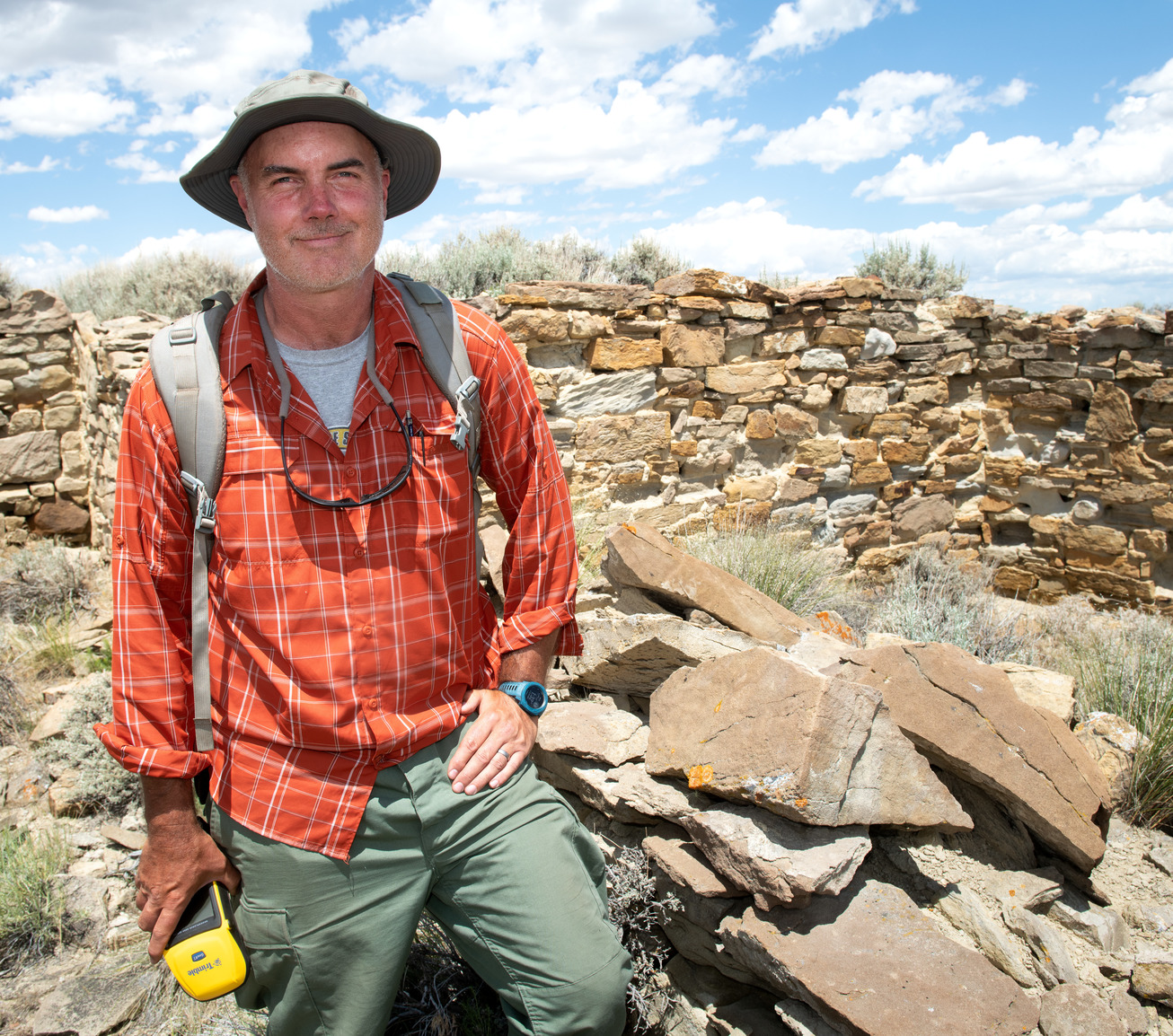 Anthropology professor posing at dig site