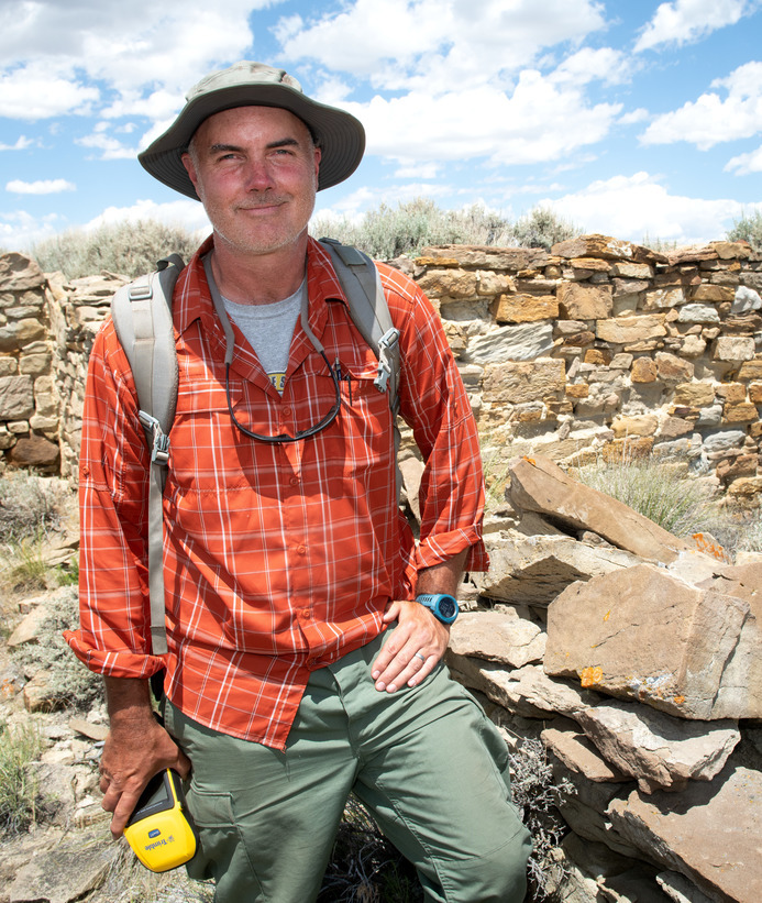 Anthropology professor posing at dig site