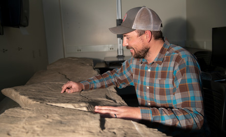 Student examining rock fixtures