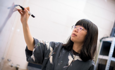Professor teaching at white board.