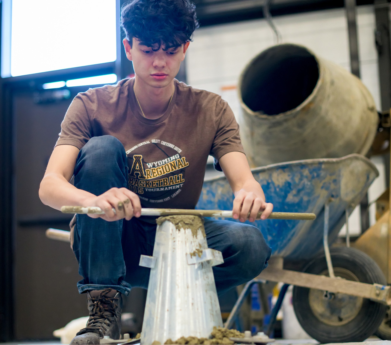 Student working with concrete in a lab