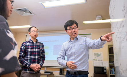 Professor teaching at white board
