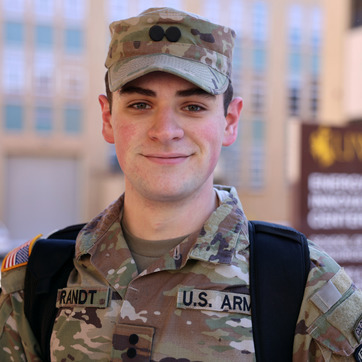 A military student smiles for a photo