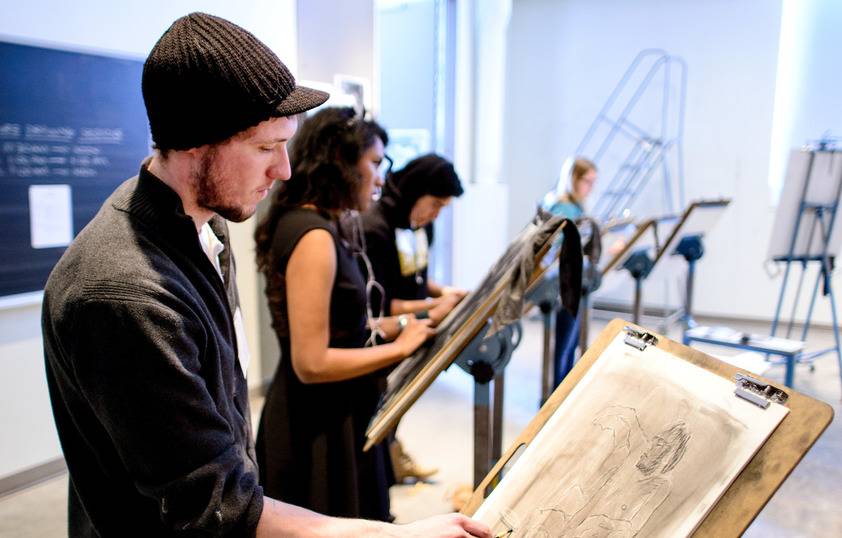 students are drawing in a studio classroom