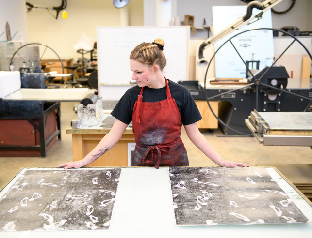 Student with their artwork