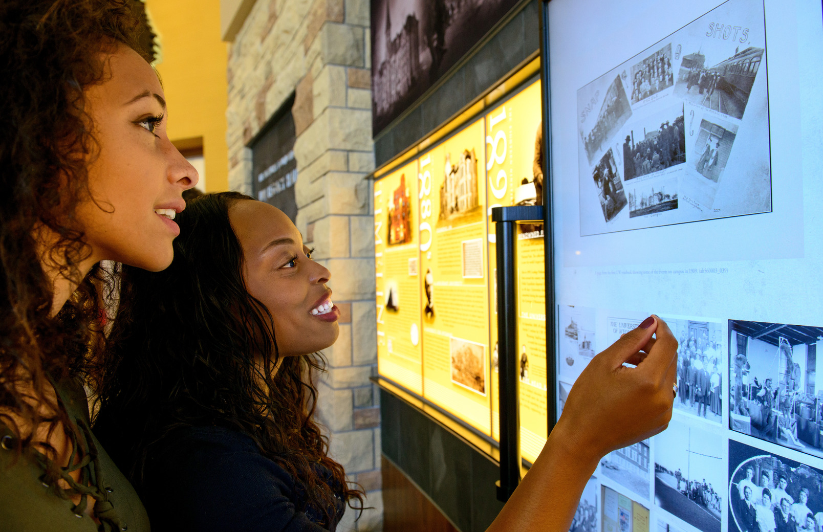 People looking at historical images in an exhibit