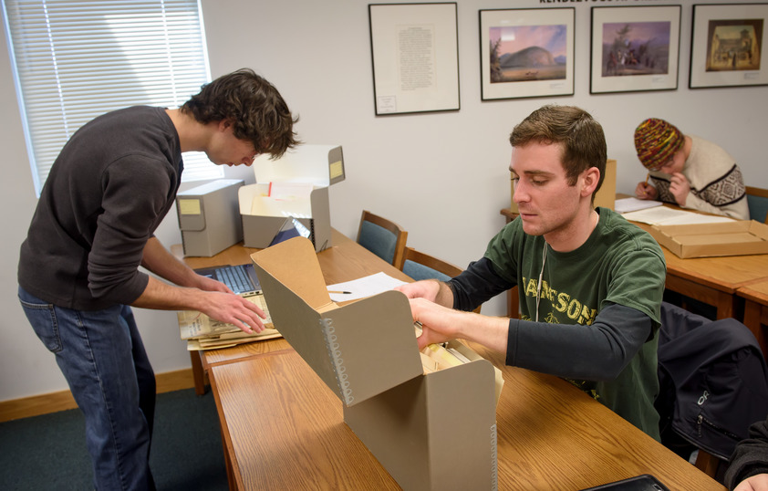 Students sifting through old art photos