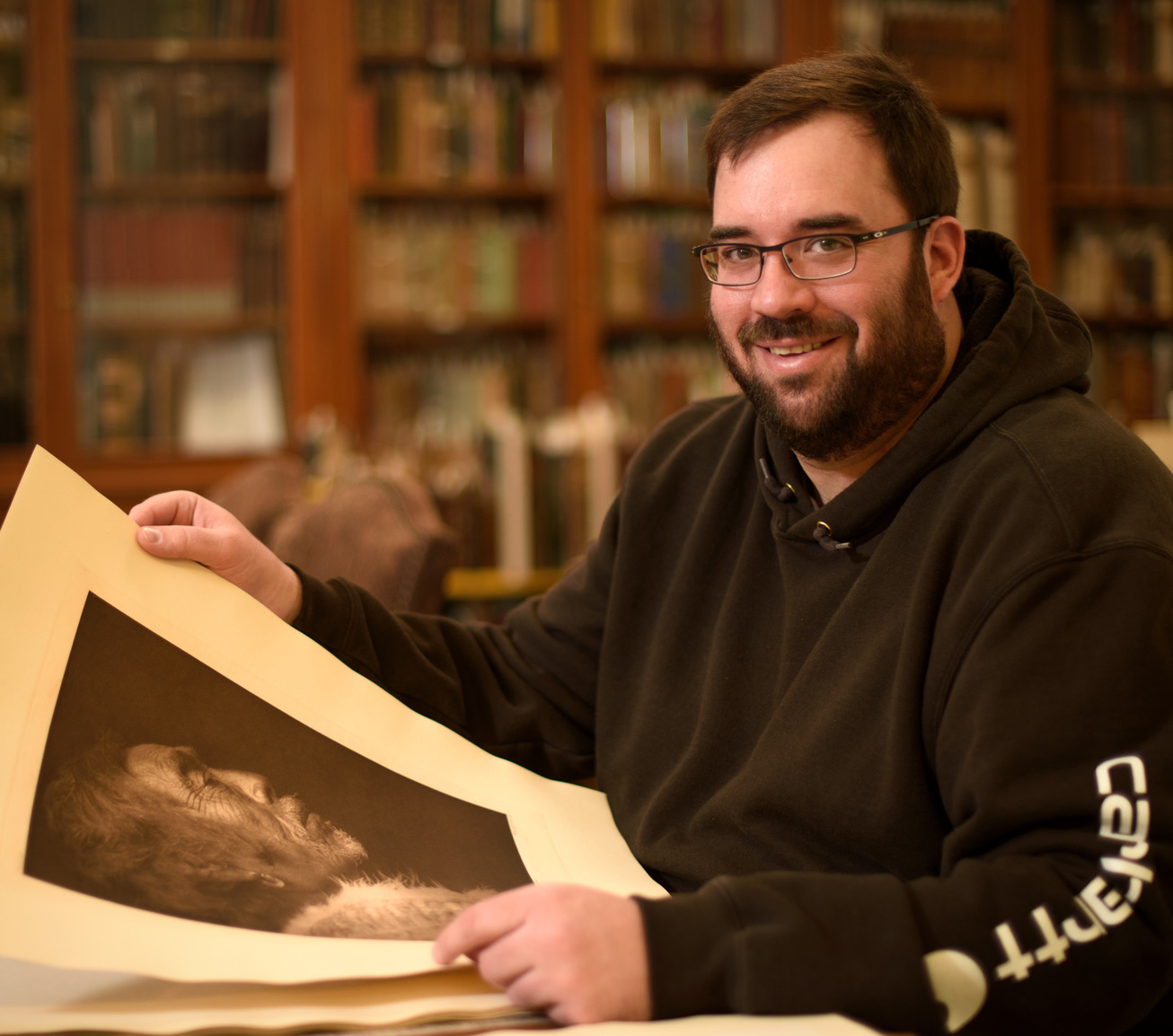 Student examining old Native American photo
