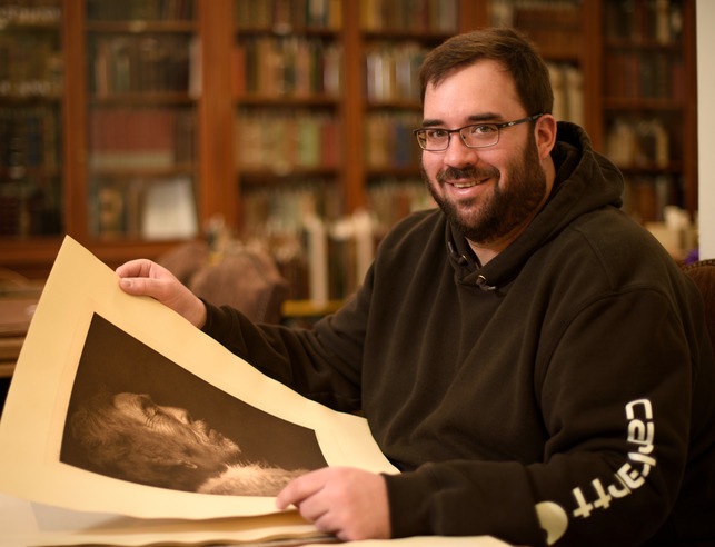 Student examining old Native American photo