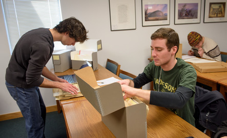 Students looking through historic archives