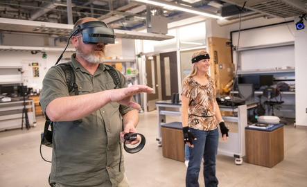 Two students working with virtual reality add-ons