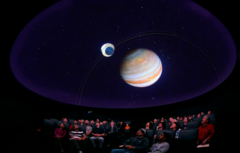 People viewing show in planetarium