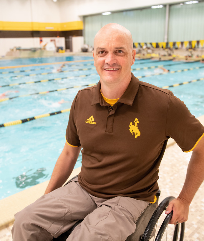 A coach smiling at a swim practice