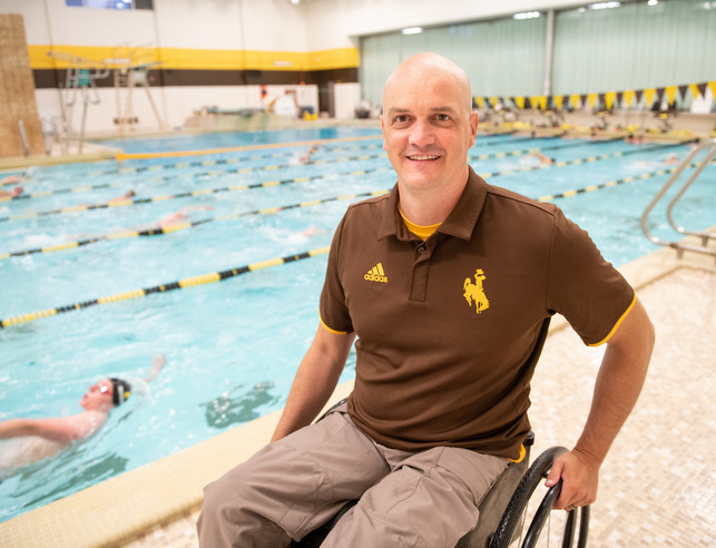 A coach smiling at a swim practice