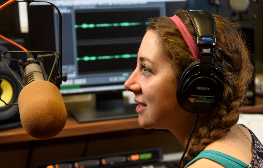 Student talking into a microphone for WPR