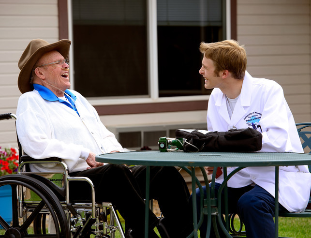 Nursing student with client laughing together