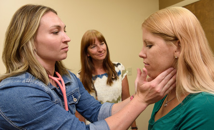 Student and professor working with patient