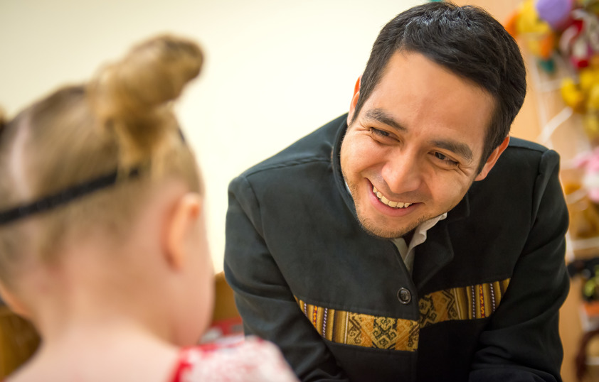 Teacher smiling at student