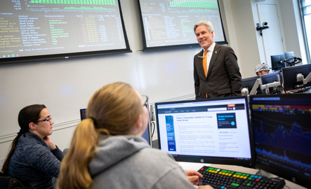 Professor and teachers in trading room