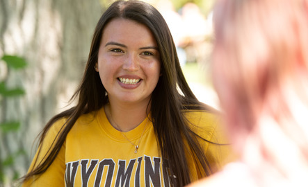 A student smiles at a friend