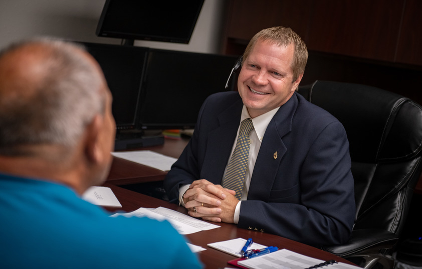 College of Business alum in his office