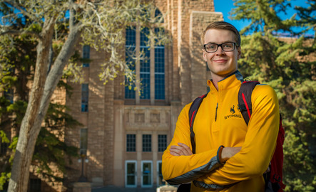 An engineering student poses for a photo outside the Engineering Building