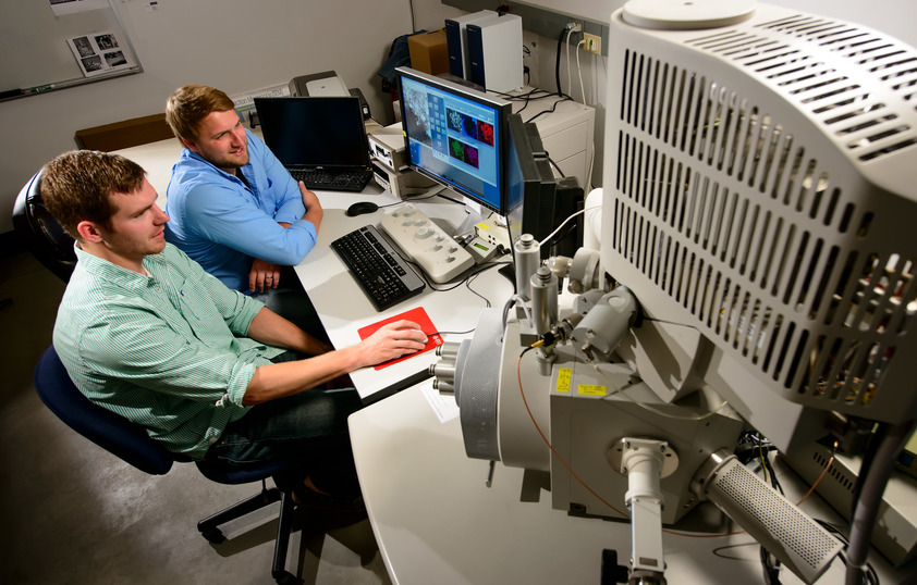 Two researchers work together on a computer