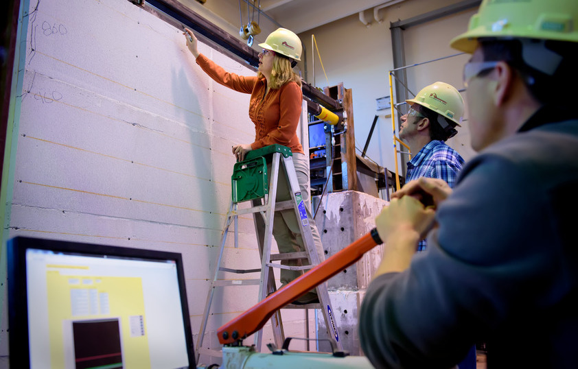 Students and teacher measuring a wall