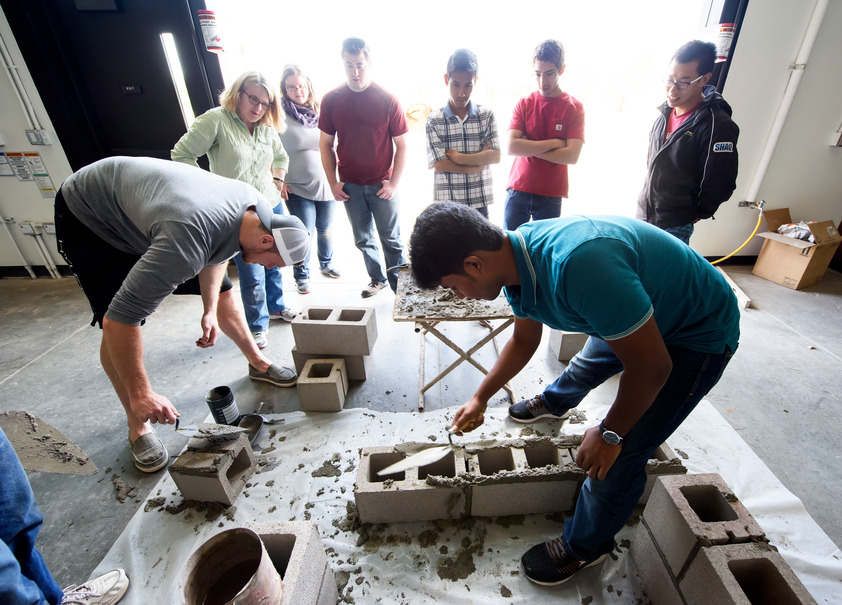 Students and teachers building structures