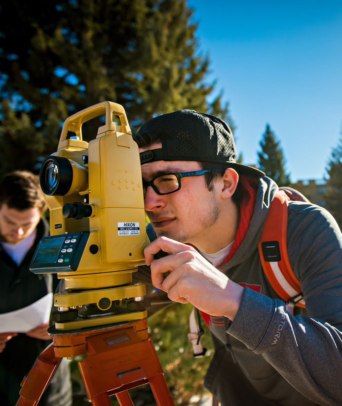 Student looking through civil engineering equipment