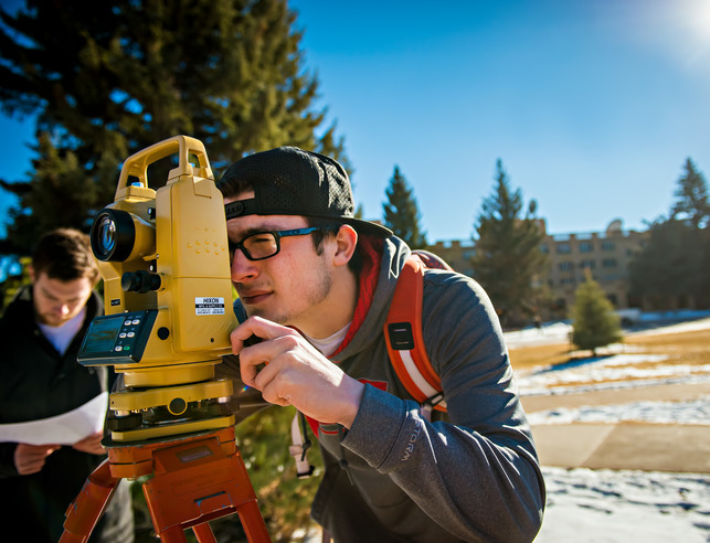 Student looking through civil engineering equipment