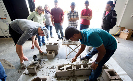Students and teachers building structures