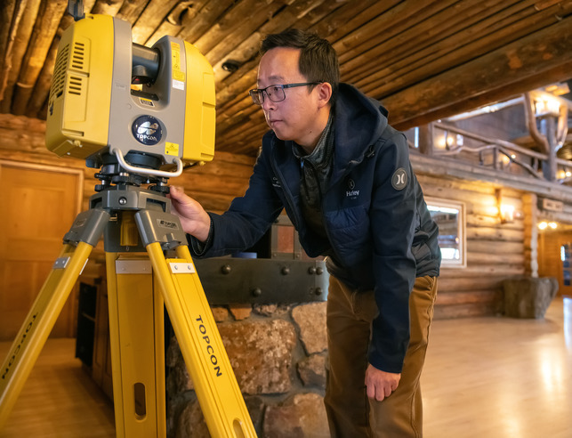 Civil engineer setting up equipment on site