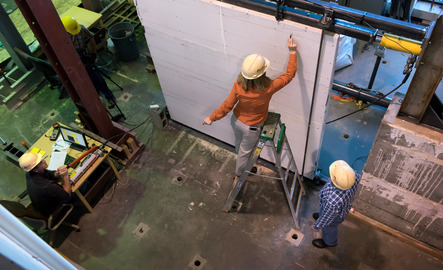 Civil engineering faculty measuring and marking a wall