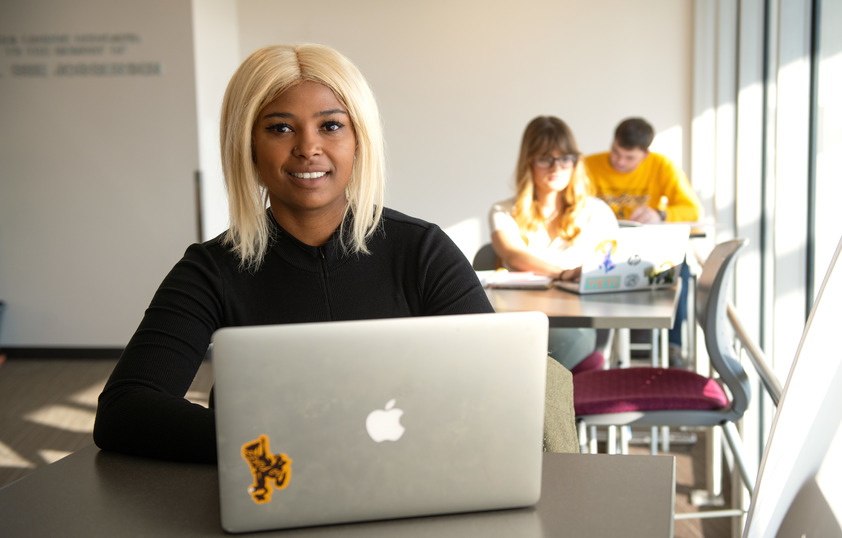 Student in class with laptop