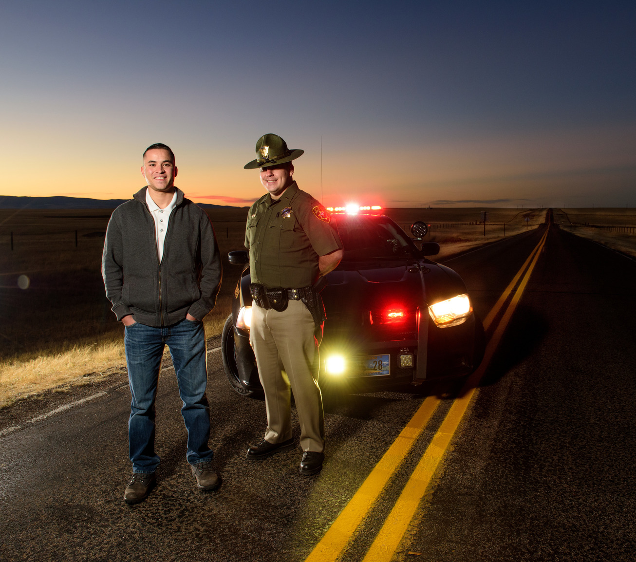 State troopers stand in front of police car