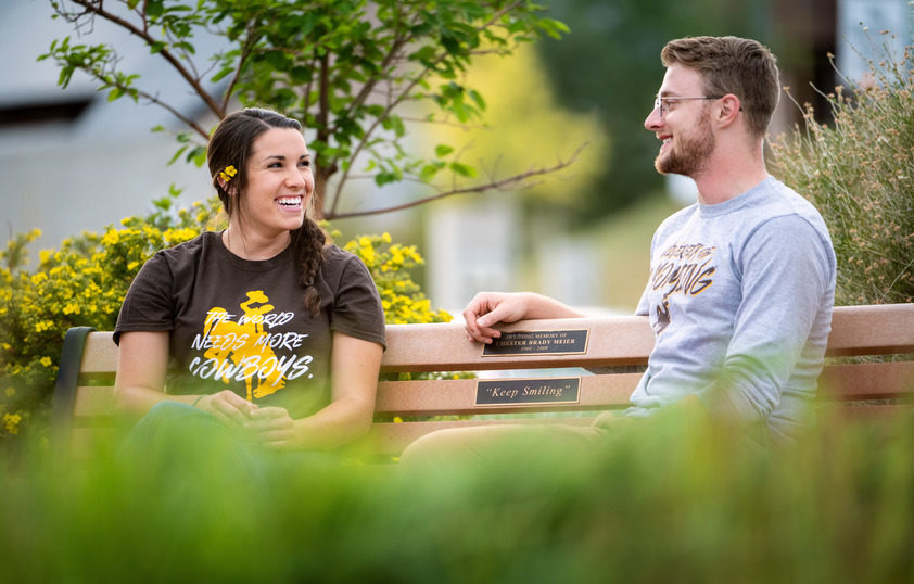 Students sitting on bench together