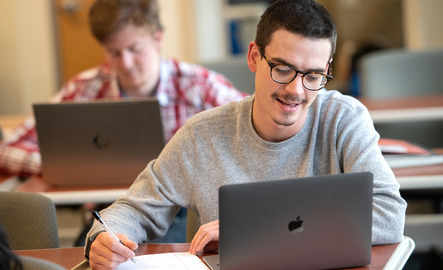 Student on laptop in communication class