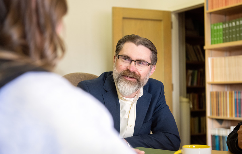 Staff member talking to someone in their office