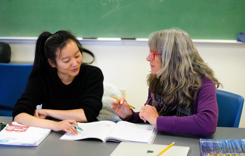 A professor and student work together in a classroom