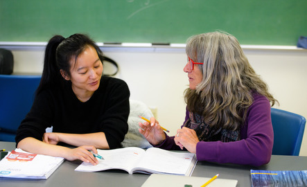 A professor and student work together in a classroom