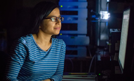 Student on their computer in a dark room