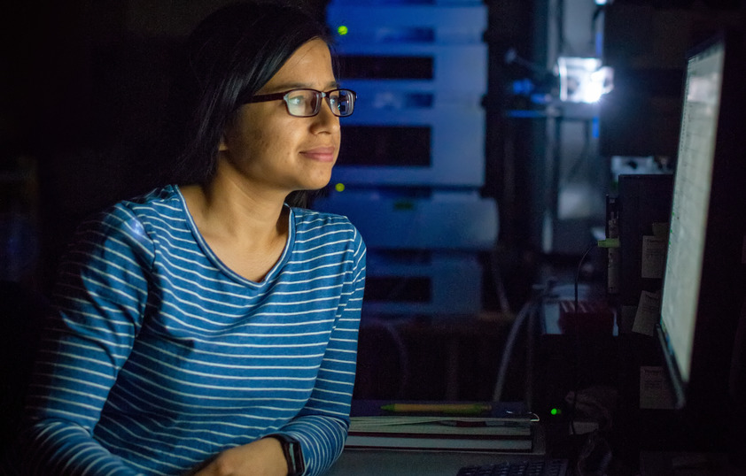 Student on their computer in a dark room