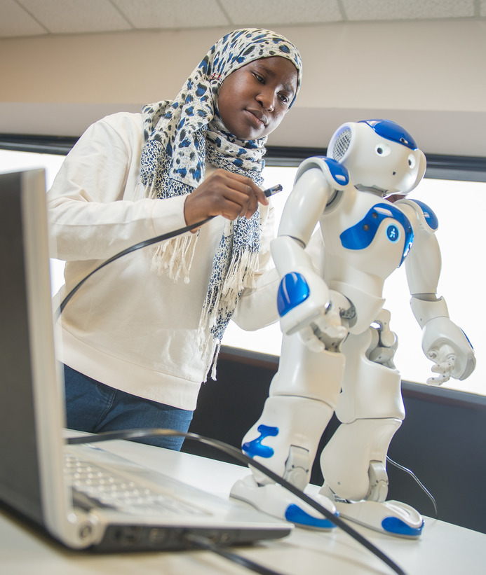 Student with robot and computer