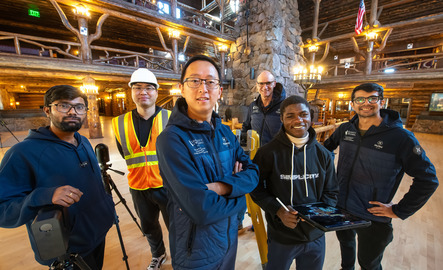 A group of construction management faculty and students smile for a photo