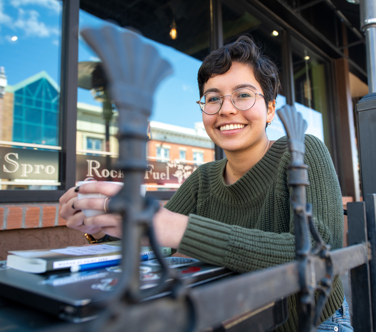 A student drinks coffee while taking a a break from writing at a local coffee shop in Laramie.