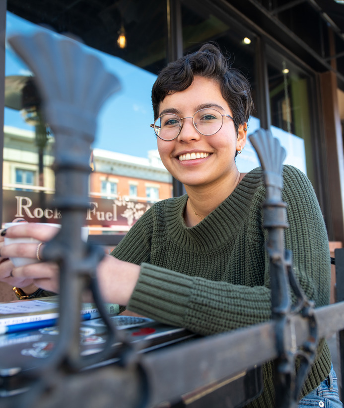 A student drinks coffee while taking a a break from writing at a local coffee shop in Laramie