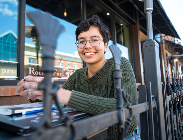 A student drinks coffee while taking a a break from writing at a local coffee shop in Laramie