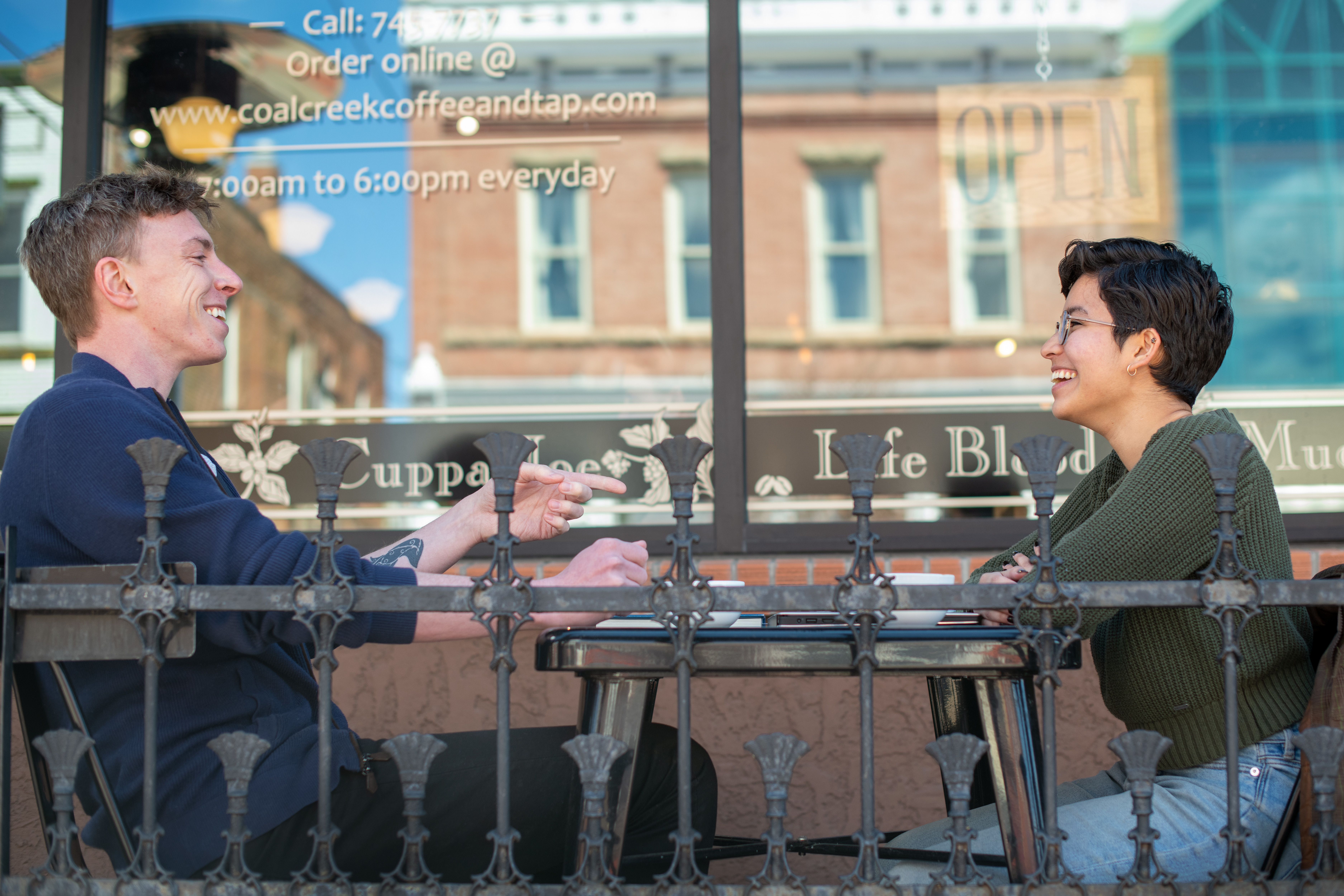 Two UW students talk at a local coffee shop